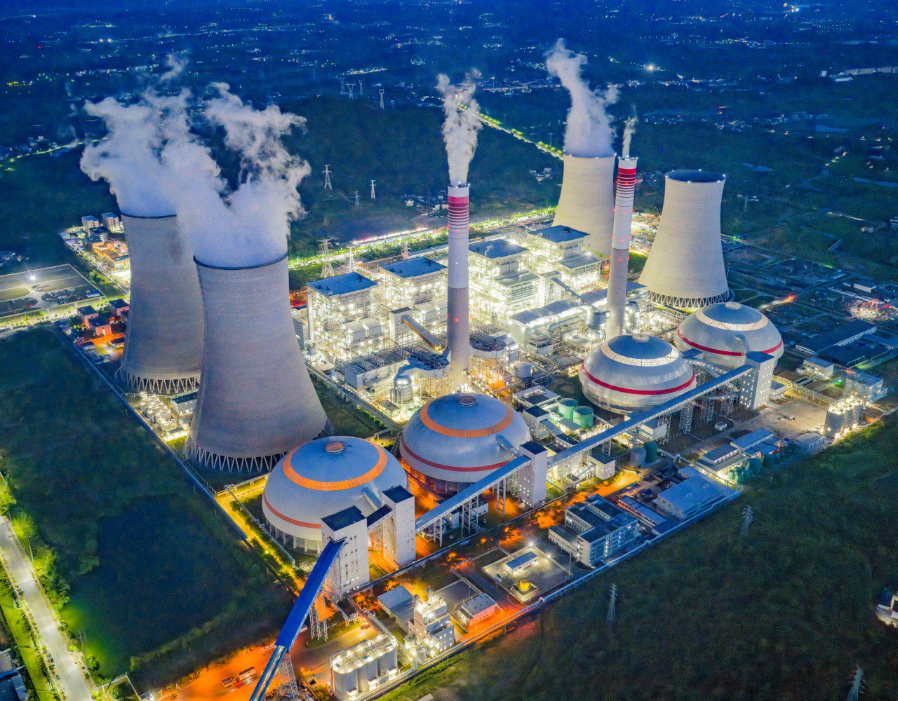 Aerial view of illuminated power plant at night