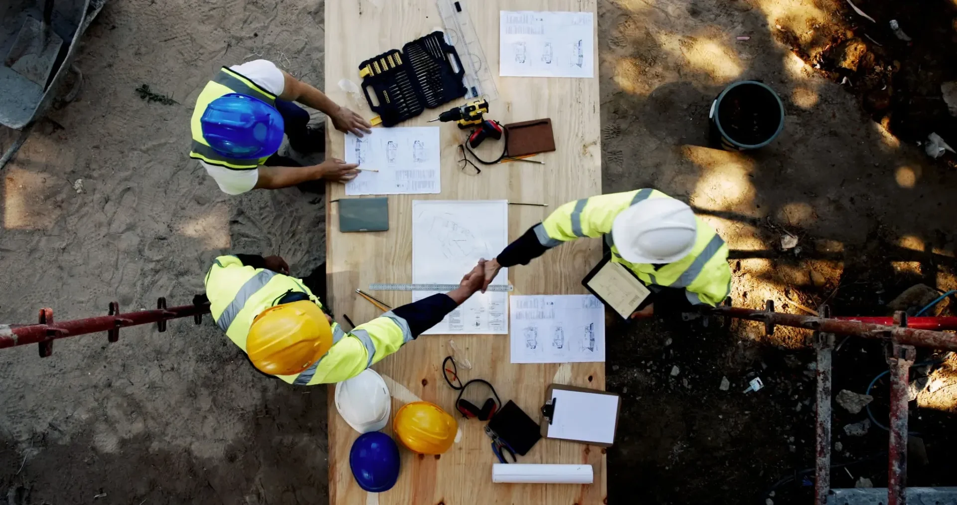 Aerial view of construction workers shaking hands